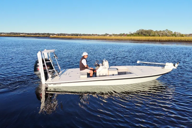Slide: The Image of 2019 Maverick 18 HPX-V boat on calm water with a person navigating. - 34