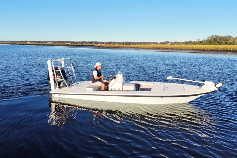 Slide: The Image of 2019 Maverick 18 HPX-V boat cruising on calm water under clear blue sky. - 35