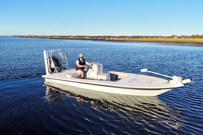 Slide: The Image of 2019 Maverick 18 HPX-V boat cruising on calm water under clear blue sky. - 36