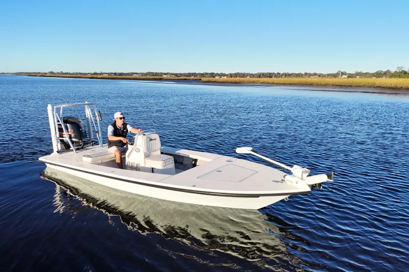 Slide: The Image of 2019 Maverick 18 HPX-V boat cruising on calm waters under clear blue skies. - 37
