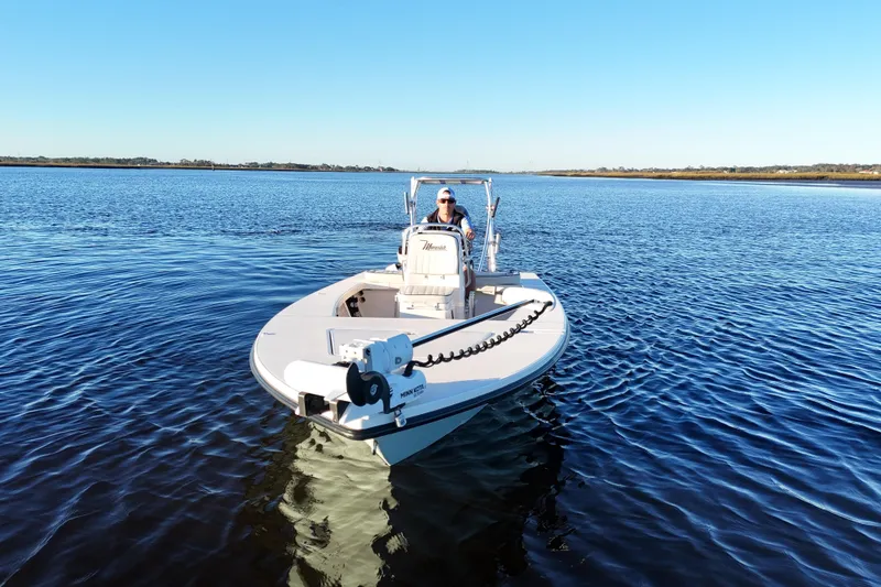 Slide: The Image of 2019 Maverick 18 HPX-V boat on calm water under clear blue sky. - 38