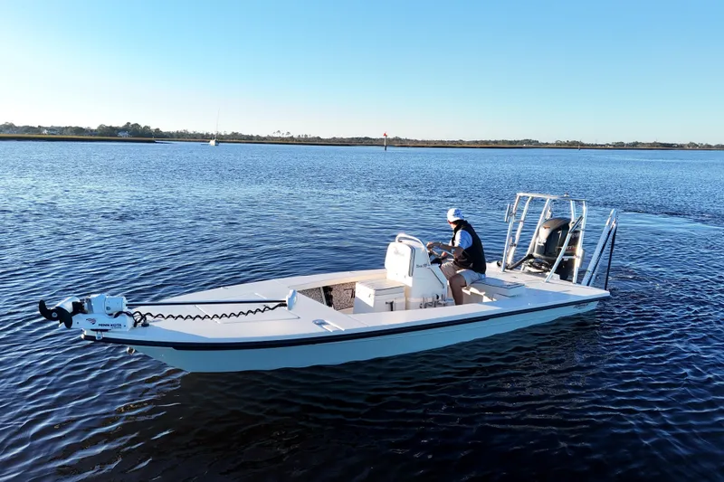 Slide: The Image of 2019 Maverick 18 HPX-V boat on calm water with a person steering. - 39
