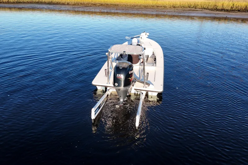 Slide: The Image of 2019 Maverick 18 HPX-V boat on calm water, rear view with outboard motor. - 44