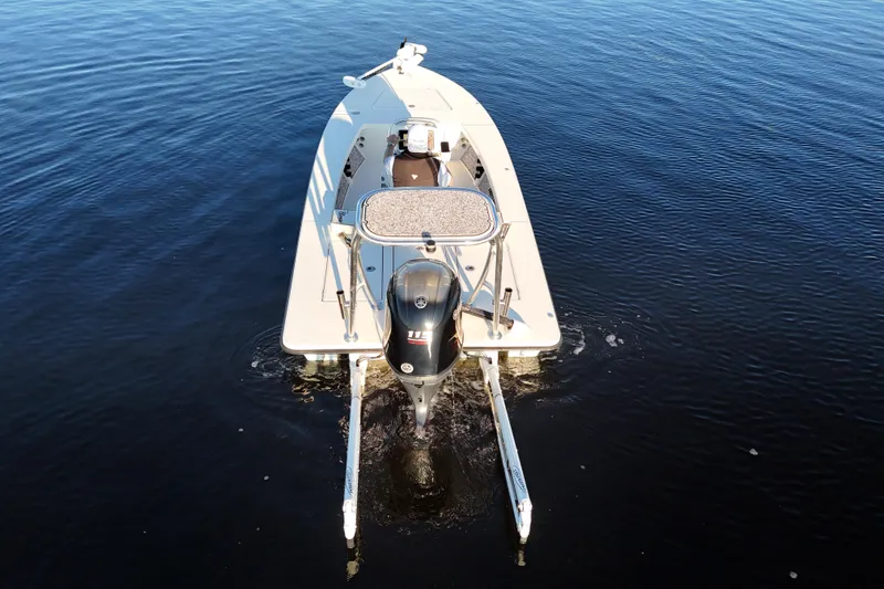 Slide: The Image of 2019 Maverick 18 HPX-V boat on calm water, rear view with motor. - 45