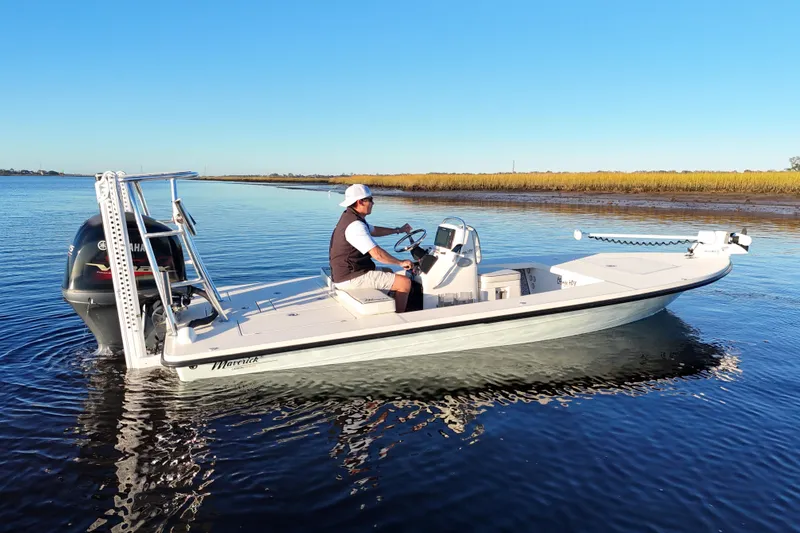 Slide: The Image of 2019 Maverick 18 HPX-V boat on calm water with a person steering. - 50