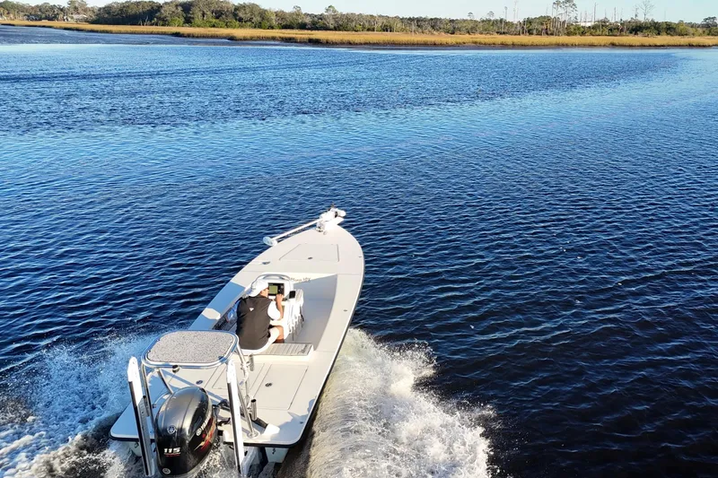 Slide: The Image of 2019 Maverick 18 HPX-V boat cruising on a serene lake. - 51