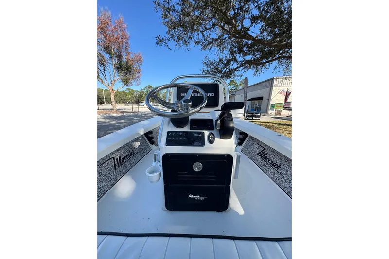 Slide: The Image of 2019 Maverick 18 HPX-V boat console with steering wheel and controls, outdoor setting. - 66