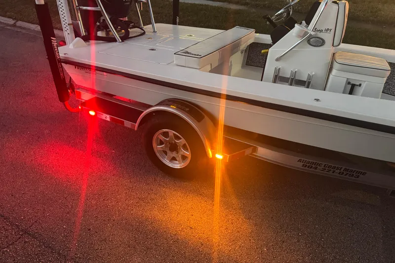 Slide: The Image of 2019 Maverick 18 HPX-V boat on trailer with illuminated rear lights at dusk. - 79