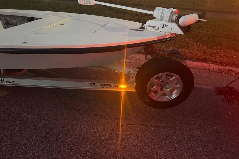 Slide: The Image of 2019 Maverick 18 HPX-V boat on AmeraTrail trailer with Minn Kota motor, parked on pavement. - 81