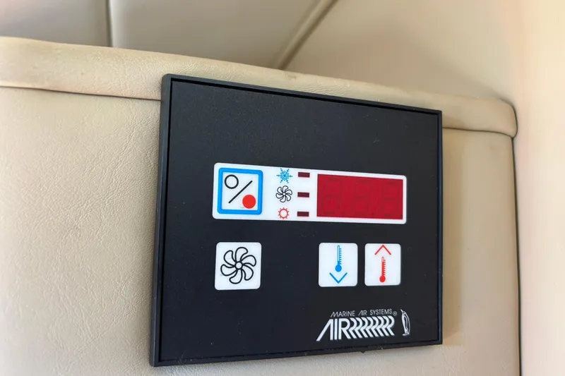 Slide: The Image of Control panel of a 2005 Rinker Fiesta Vee 250 boat's air conditioning system. - 18