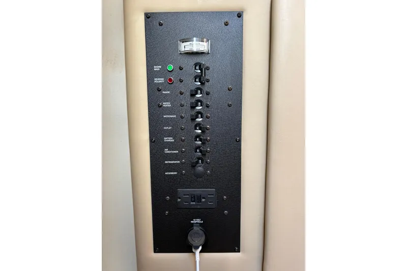 Slide: The Image of Control panel of 2005 Rinker Fiesta Vee 250 boat with labeled switches and indicators. - 20