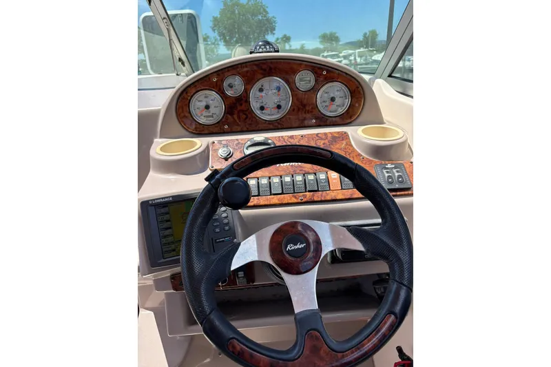 Slide: The Image of 2005 Rinker Fiesta Vee 250 dashboard with steering wheel and instrument panel. - 3