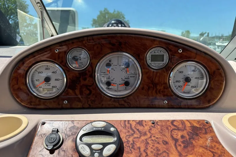 Slide: The Image of Dashboard of a 2005 Rinker Fiesta Vee 250 boat with gauges and controls. - 4