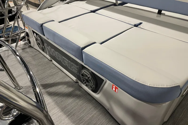 Slide: The Image of 2026 Harris Grand Mariner SEL 250 boat interior with cushioned seating and speaker system. - 11