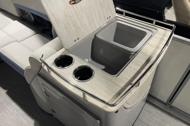 Slide: The Image of 2026 Harris Grand Mariner SEL 250 boat interior with built-in cooler and cup holders. - 13