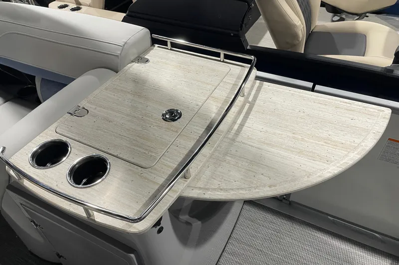 Slide: The Image of 2026 Harris Grand Mariner SEL 250 boat interior with elegant table and cup holders. - 14