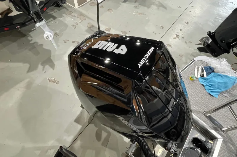 Slide: The Image of 2026 Harris Grand Mariner SLEC 250 with Mercury outboard engine, displayed indoors. - 28