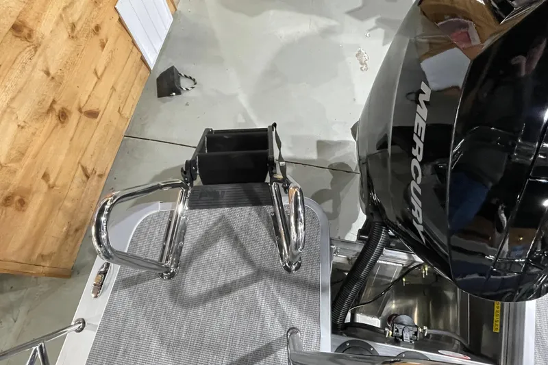 Slide: The Image of 2026 Harris Grand Mariner SLEC 250 boat with Mercury engine, docked indoors. - 29