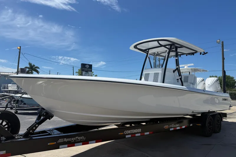 The Image of 2026 Contender 29 Bay boat on trailer under clear blue sky. - 0