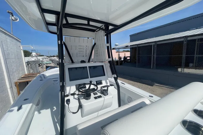 Slide: The Image of 2026 Contender 29 Bay boat interior with cushioned seating and storage compartments. - 10