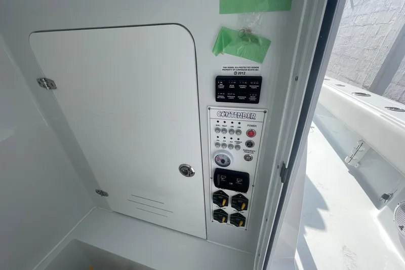 Slide: The Image of 2026 Contender 29 Bay boat interior with JL Audio speaker, white seating, and clear sky. - 11