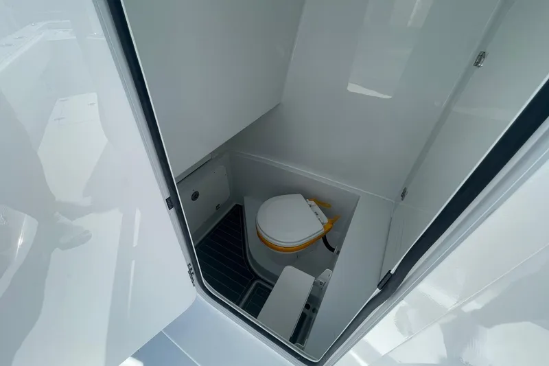 Slide: The Image of 2026 Contender 29 Bay boat interior with compact marine toilet. - 12