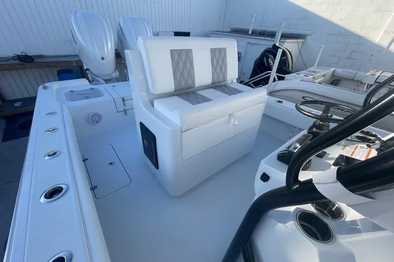 Slide: The Image of 2026 Contender 29 Bay boat interior with dual engines and modern seating. - 18