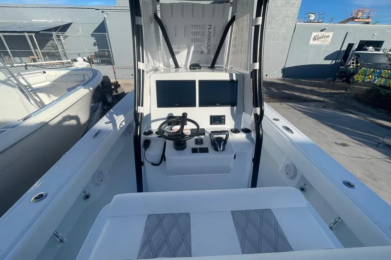 Slide: The Image of 2026 Contender 29 Bay boat cockpit with modern steering and controls. - 20