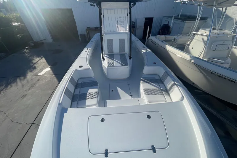 Slide: The Image of 2026 Contender 29 Bay boat with spacious seating and sleek design in a marina setting. - 22