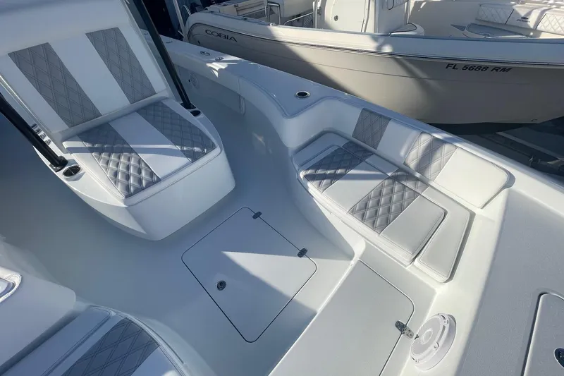 Slide: The Image of 2026 Contender 29 Bay boat interior with cushioned seating and storage compartments. - 23