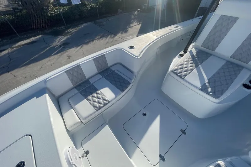 Slide: The Image of 2026 Contender 29 Bay boat interior with diamond-stitched seating and storage compartments. - 24