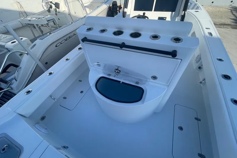 Slide: The Image of 2026 Contender 29 Bay boat interior with fishing rod holders and storage compartments. - 26