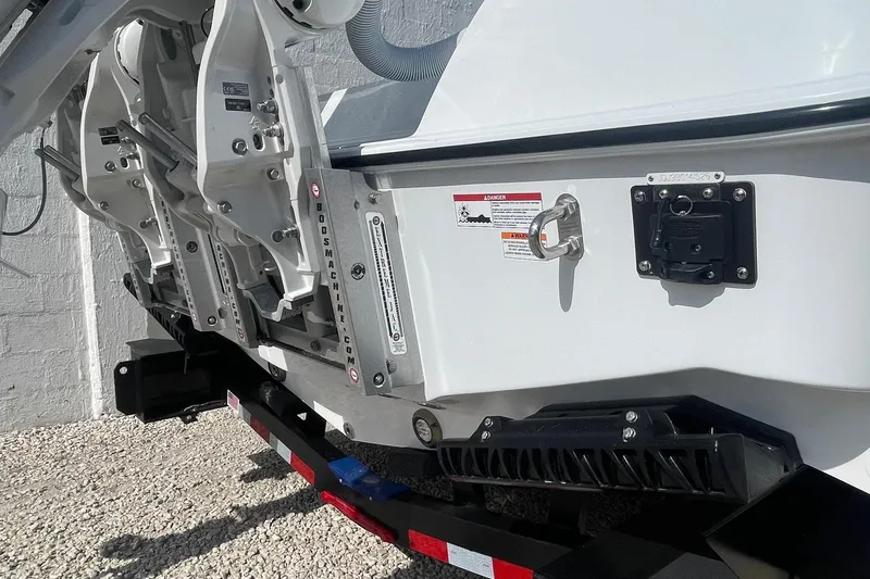 Slide: The Image of 2026 Contender 29 Bay boat transom with dual engine mounts and safety warnings. - 3