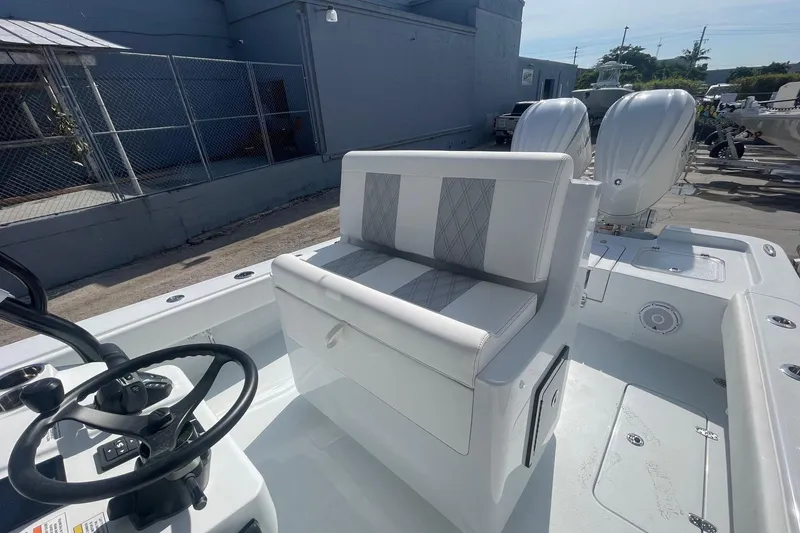 Slide: The Image of 2026 Contender 29 Bay boat with open storage compartments on deck. - 9