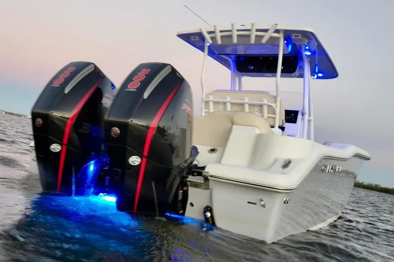 The Image of 2022 Key West 263 FS boat with dual engines and blue LED lights on water. - 0