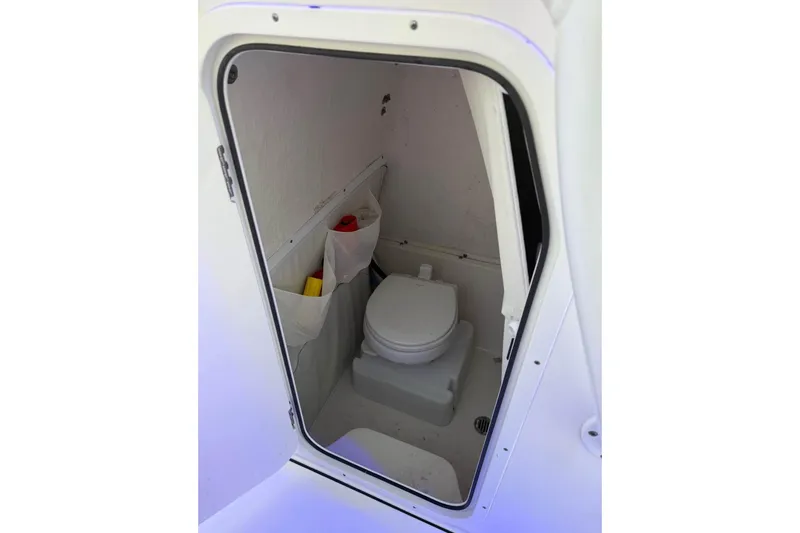 Slide: The Image of 2022 Key West 263 FS boat interior with compact marine toilet. - 16
