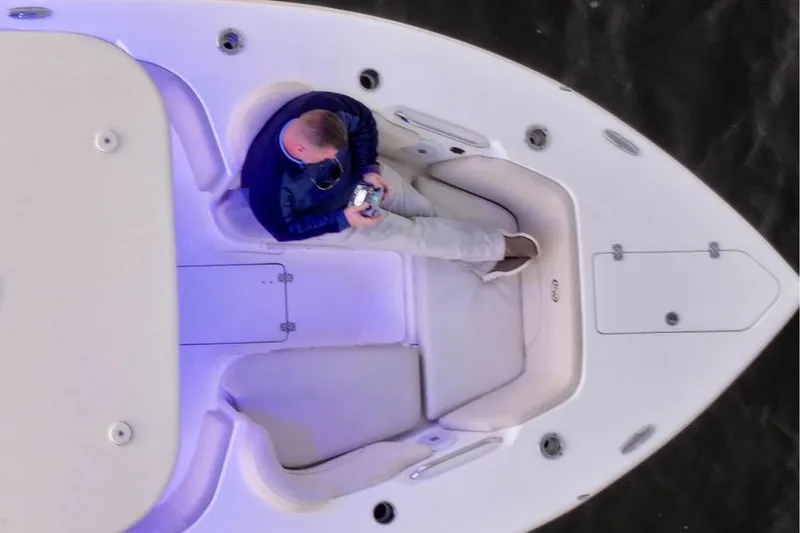 Slide: The Image of Overhead view of a person relaxing on a 2022 Key West 263 FS boat. - 7