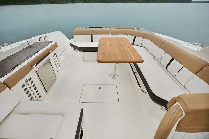 Slide: The Image of Luxurious seating area on 2021 Sea Ray SLX 400 boat, featuring elegant upholstery and wooden table. - 12