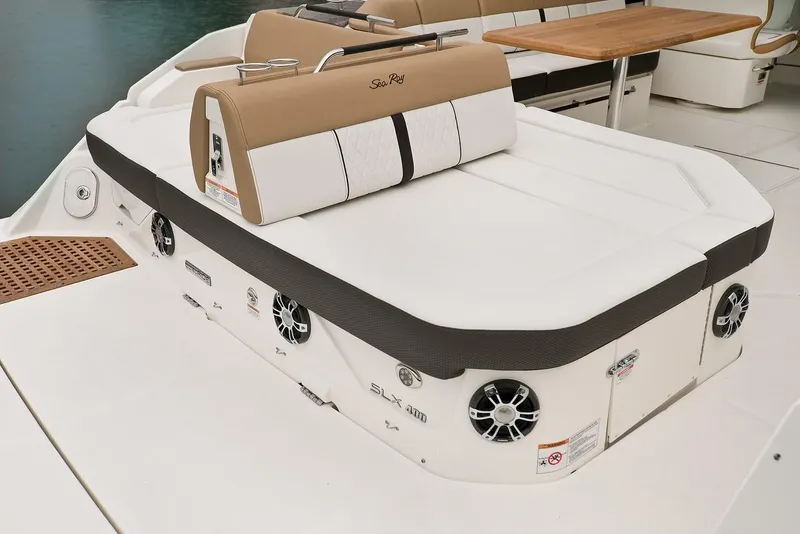 Slide: The Image of Luxurious 2021 Sea Ray SLX 400 boat interior with elegant seating and wooden table. - 15