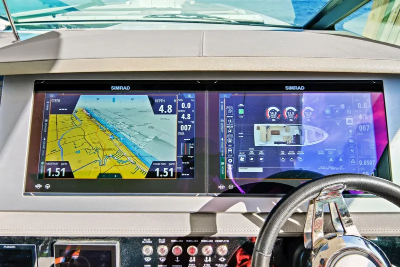 Slide: The Image of Dashboard of 2021 Sea Ray SLX 400 with dual Simrad navigation displays. - 25