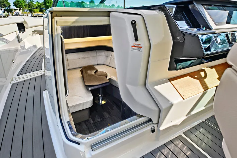 Slide: The Image of 2021 Sea Ray SLX 400 interior cabin with seating and table, showcasing luxury design. - 33