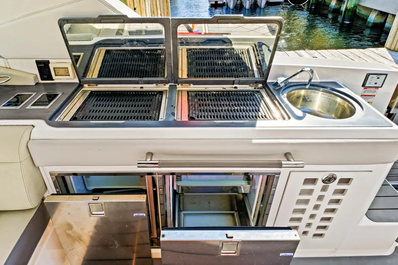 Slide: The Image of Outdoor kitchen on 2021 Sea Ray SLX 400 yacht with grill, sink, and storage. - 35