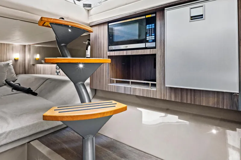 Slide: The Image of Interior of 2021 Sea Ray SLX 400 yacht with modern kitchen and cozy seating area. - 36