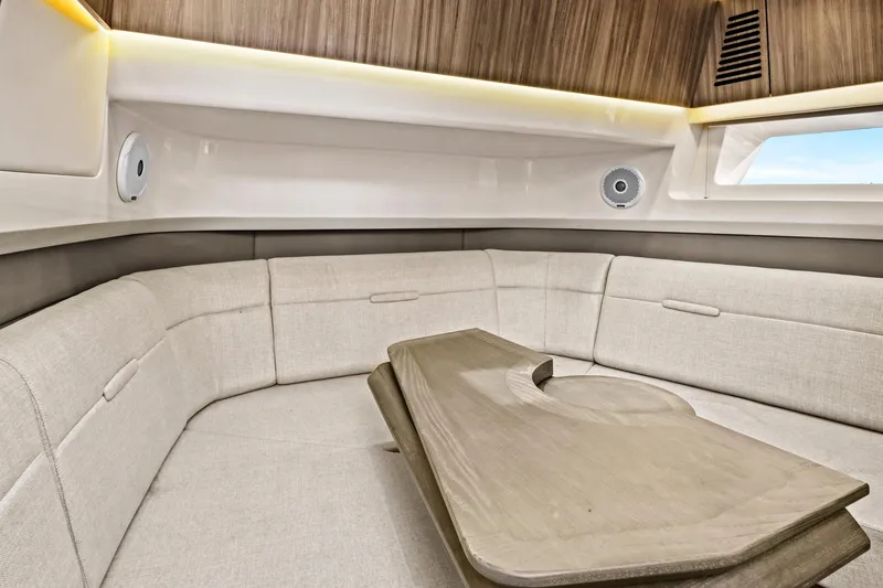 Slide: The Image of Luxurious interior of 2021 Sea Ray SLX 400 boat with elegant seating and wooden table. - 40