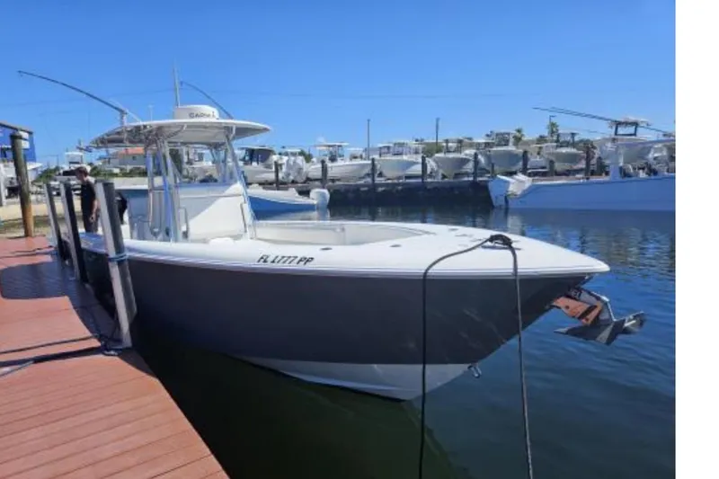 The Image of 2019 Contender 35 ST boat docked at marina under clear blue sky. - 0
