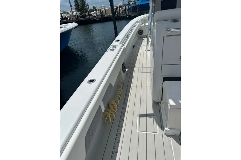 Slide: The Image of 2019 Contender 35 ST boat deck with clean, sleek design and dockside view. - 23