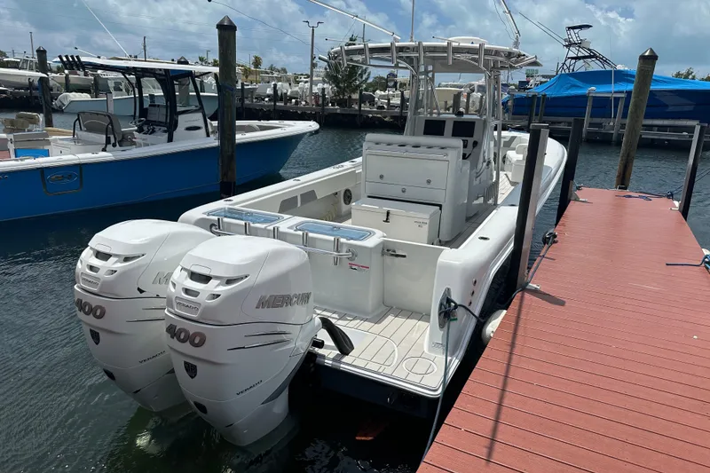 Slide: The Image of 2019 Contender 35 ST boat docked, featuring dual Mercury 400 engines. - 28