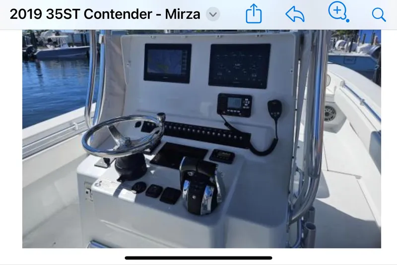 Slide: The Image of 2019 Contender 35 ST boat dashboard with steering wheel and navigation controls. - 3