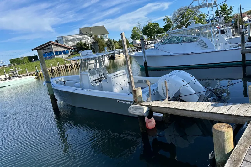 Slide: The Image of 2019 Contender 35 ST boat docked in a marina with clear blue skies. - 30