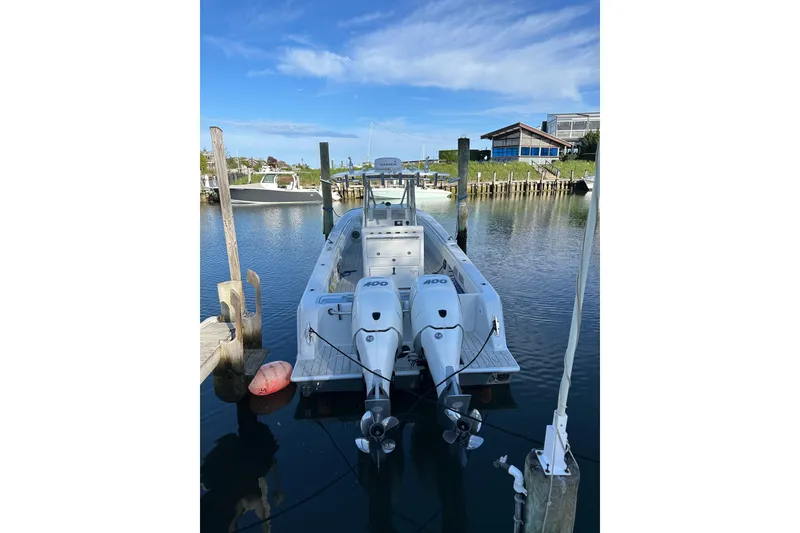 Slide: The Image of 2019 Contender 35 ST boat docked with twin 400 engines, clear sky background. - 33